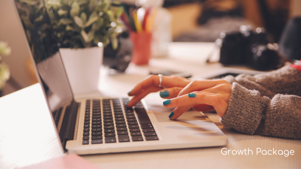 Person with blue nail polish using laptop